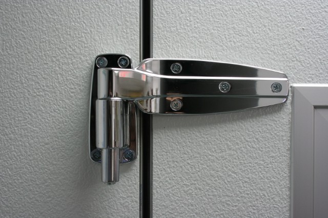 Photo of the R-Plus Doors adjustable hinge for swing doors.